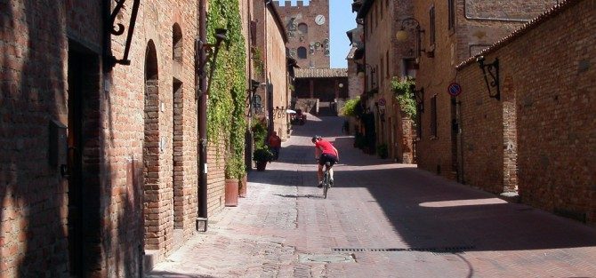 Cycling through a village in Tuscany Italy