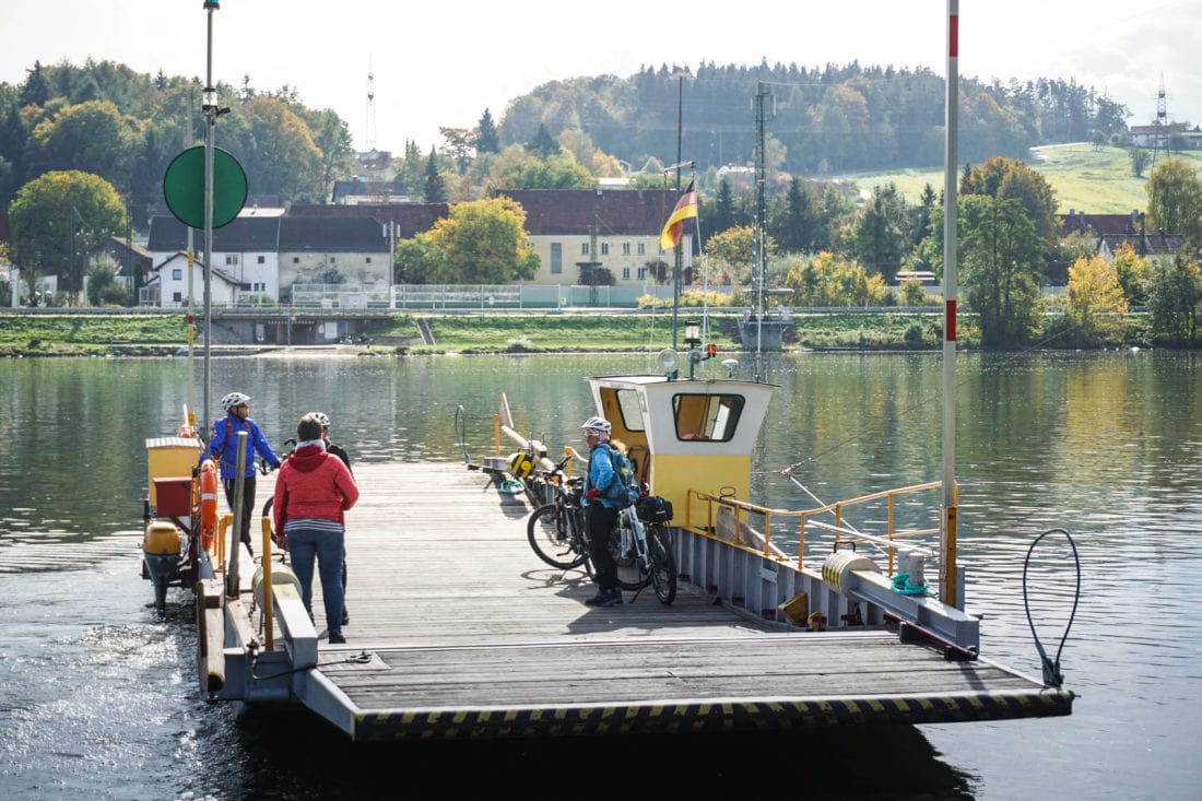 cyclists catching a ferry across the danube on a cycling tour